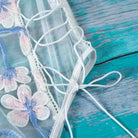 Floral Embroidered Mesh Bodysuit with Criss - Cross Harness Details - Cosparty